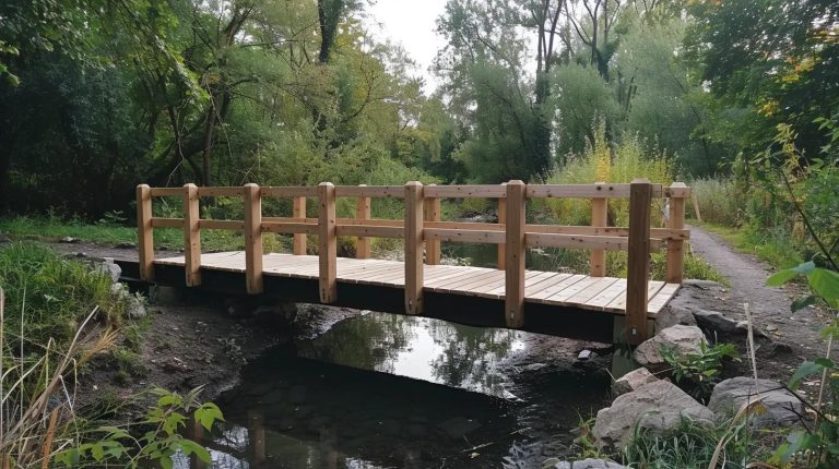 Temporary wooden bridge over a small stream surrounded by lush greenery, illustrating E&H Manufacturing's expertise in stress-laminated timber bridges for various applications.