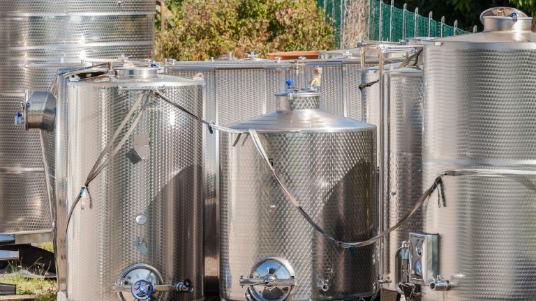 Stainless steel tanks for industrial storage, highlighting safety and compliance in manufacturing processes.